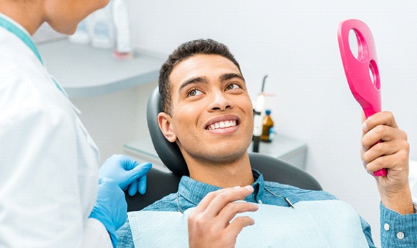 man smiling at his dentist