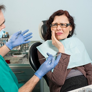 A dentist trying to help a patient with a toothache