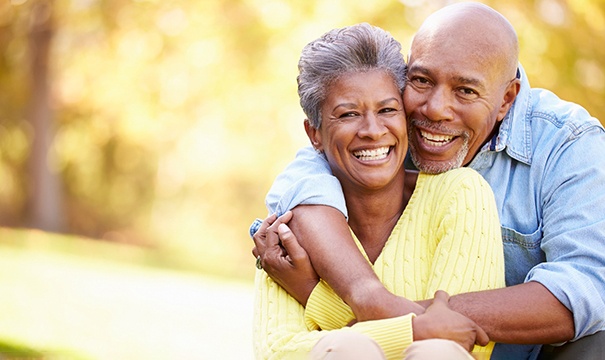 Senior man and woman smiling in a park