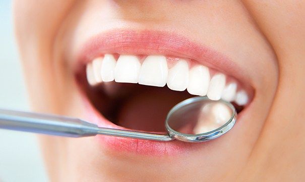 Dentist checking patient's restorative dentistry after dental filling treatment