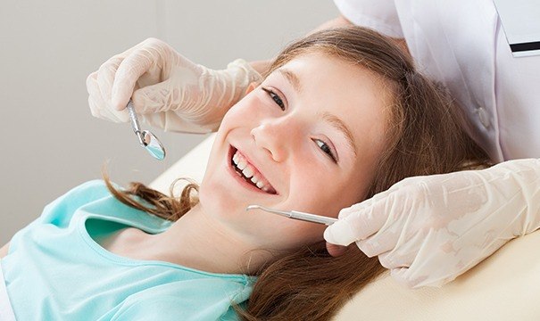 young girl in exam chair for children's dentistry