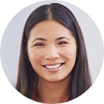 Young woman smiling in front of white background