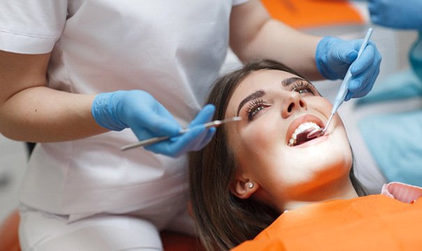 woman smiling while visiting dentist
