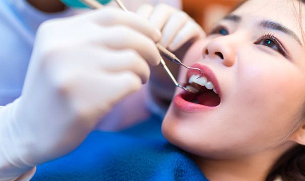 patient smiling while visiting dentist