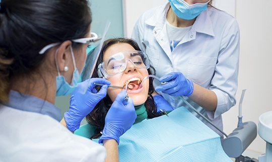 Couple smiling together after dental crown and bridge restoration