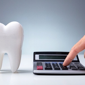 fake tooth next to a calculator