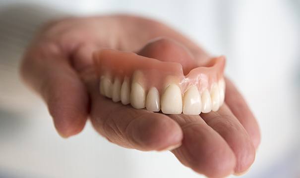 full denture in hand