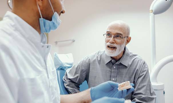 man talking to his denture dentist in Attleboro