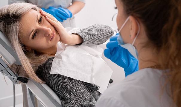 A dentist explaining the cost of emergency dentistry in Attleboro