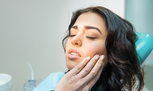 Woman in pain before emergency dentistry treatment