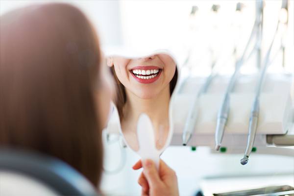 Dental team member looking at digital x-rays