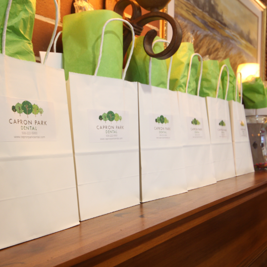 Dental team member at front desk smiling at a patient