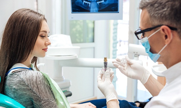 A dentist answering questions about dental implants in Attleboro