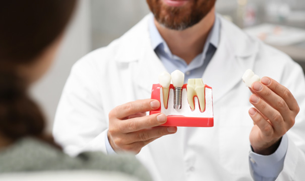 a dentist and patient chatting about dental implants