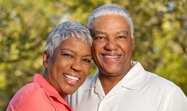 Husband and wife with dentures smiling