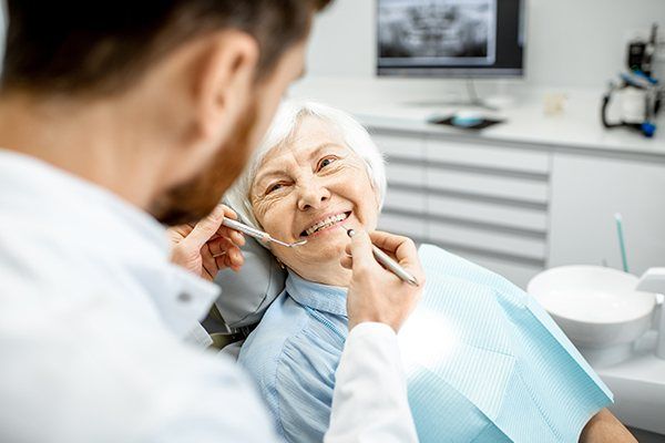 Elder dental patient receives checkup