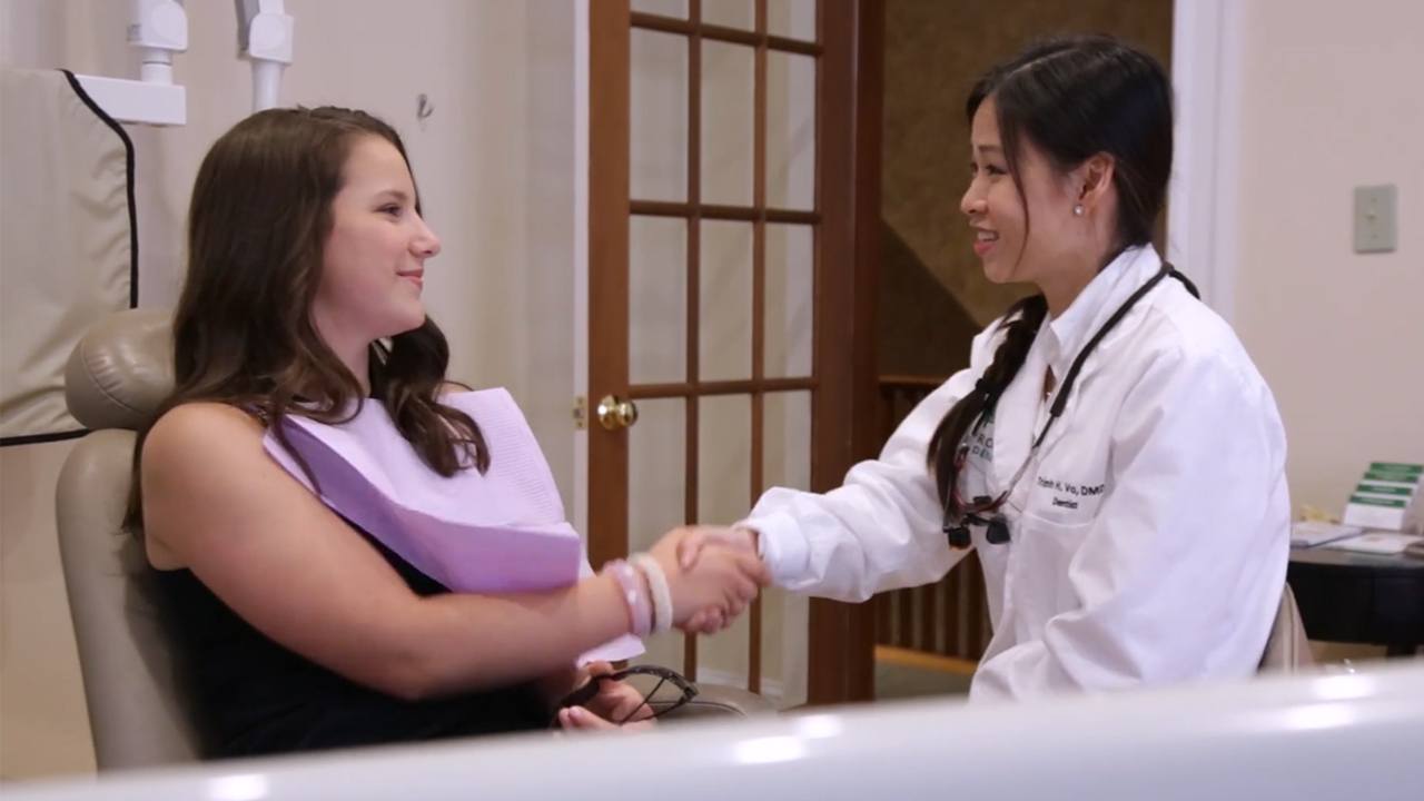 Dentist speaks with a Dental Patient