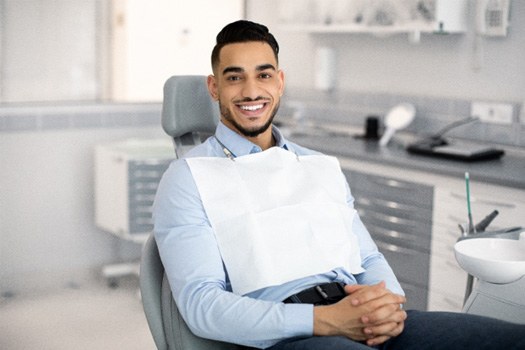 Patient smiling while sitting in treatment chair
