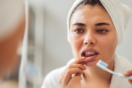 Patient looking concerned at their gums