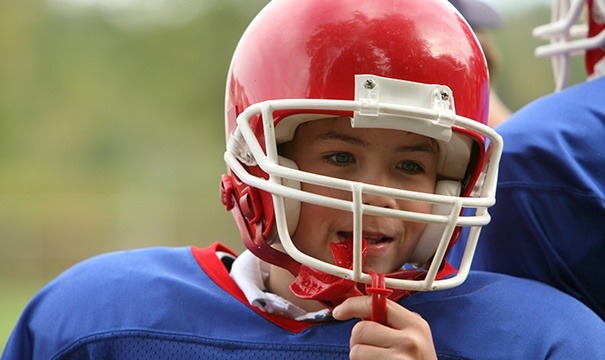 Teen boy placing mouthguard