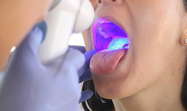 Patient receiving oral cancer screening