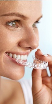 Woman holding invisalign tray