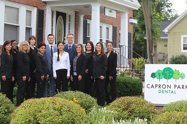 dental team in front of dental clinic