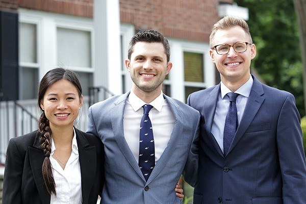 Three dentists smiling