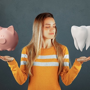 Woman balancing piggy bank and tooth representing cost of veneers in Attleboro 