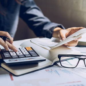 Patient with calculator sitting at their desk