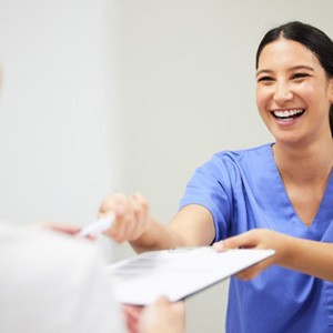 Dentist handing a patient financial information