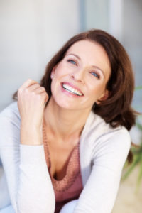 Laughing woman with brilliant smile thanks to teeth whitening 