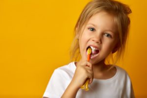 little girl brushing teeth