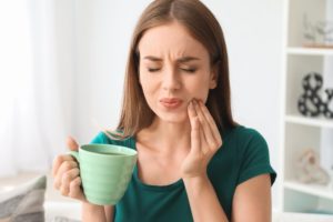 woman in pain from sensitive teeth