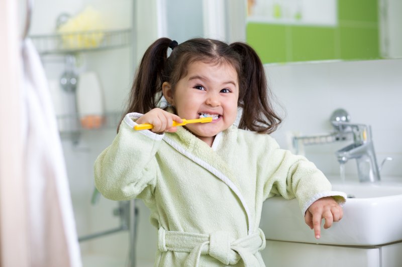 Young child brushing their teeth