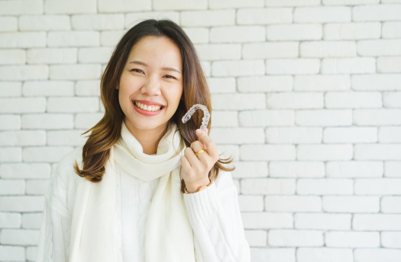 woman smiling about the benefits of Invisalign in Attleboro