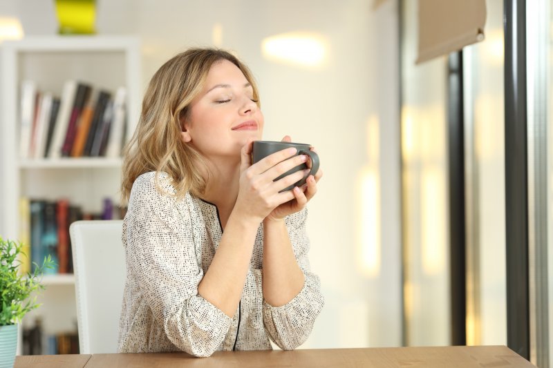 young woman drinking a cup of coffee