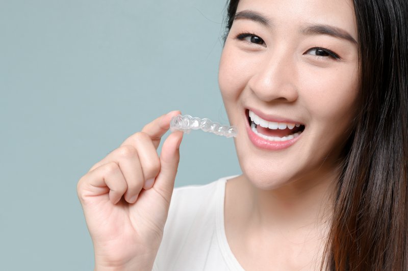 patient holding an Invisalign tray