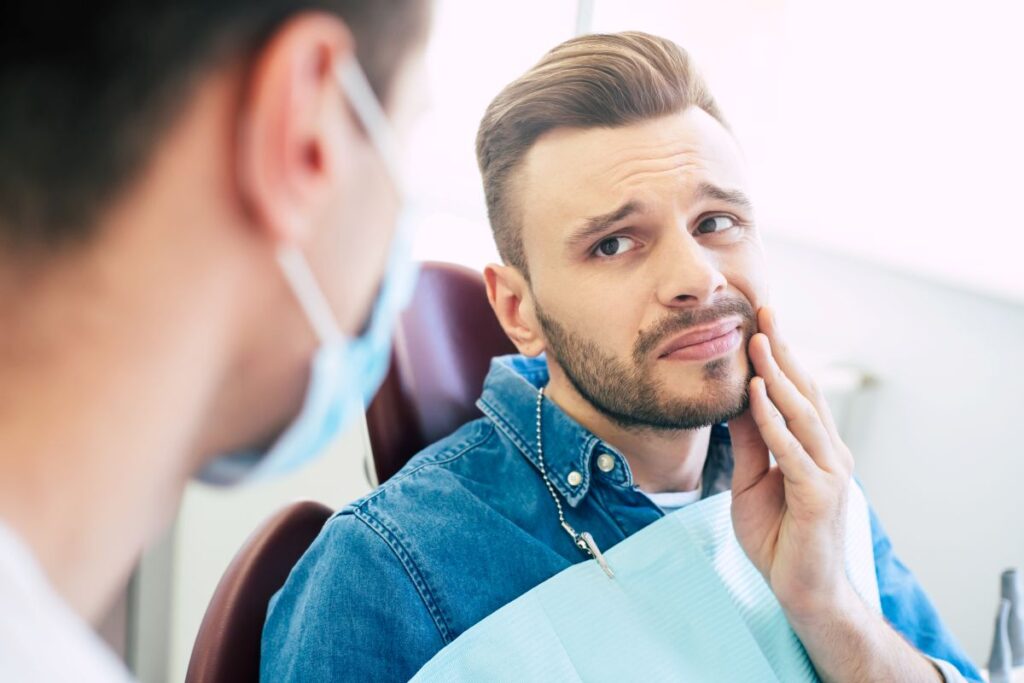 A man at the dentist with a toothache